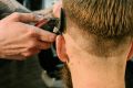 pexels-photo-4625626-4625626 Barber performing a stylish haircut on a man in a modern barbershop.