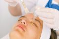 pexels-photo-5069429-5069429 A professional applying serum during a facial treatment in a modern spa setting.