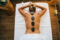 pexels-photo-6560273-6560273 A woman enjoying a rejuvenating hot stone massage in a tranquil spa setting.