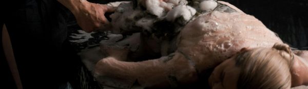 A serene spa experience with a masseur giving a relaxing bubble massage treatment.